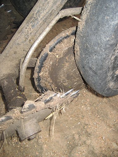 Competitor seed lock wheel clogged with mud.