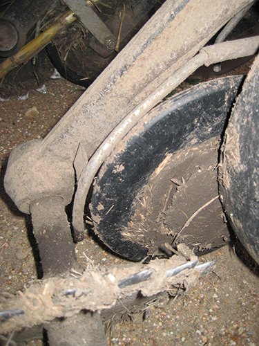Competitor seed lock wheel clogged with mud.