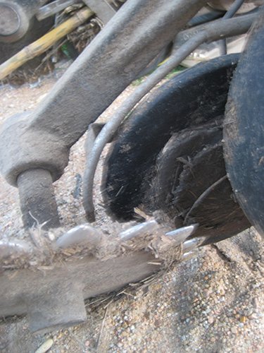 Competitor seed lock wheel clogged with mud.