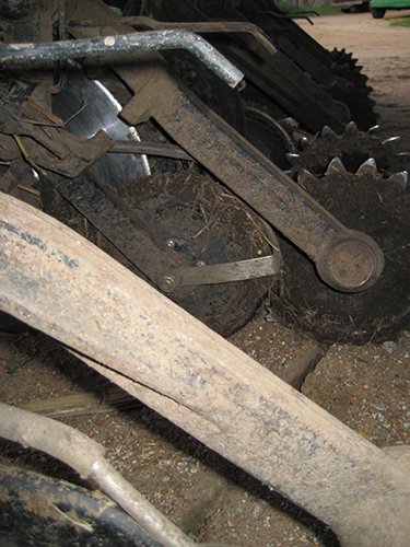 Mud buildup of a competitor seed lock wheel.