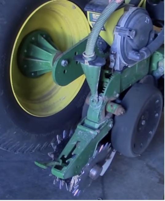 Up close look of John Deere row unit on a planter.