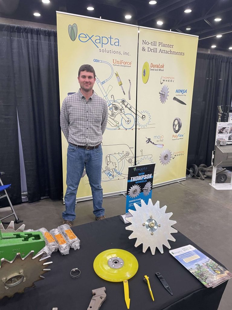 Salesman at a booth at a farm show.
