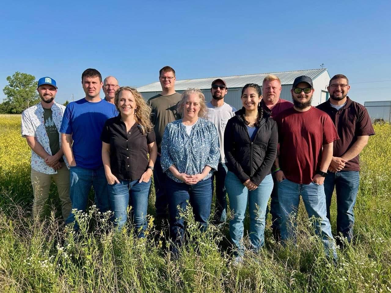 Exapta team members standing in a field.