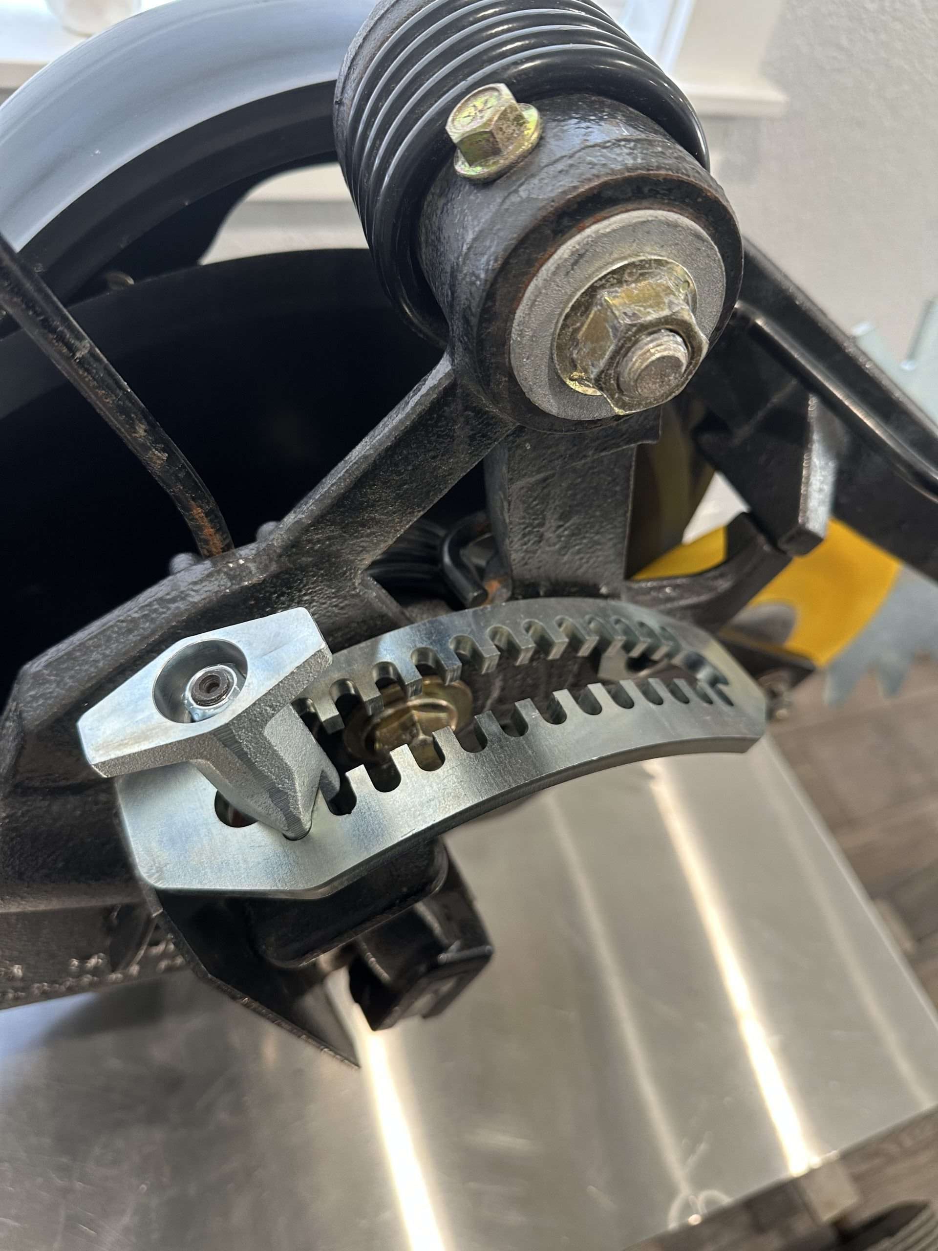 Depth adjustment plate with T-handle on a drill row unit.